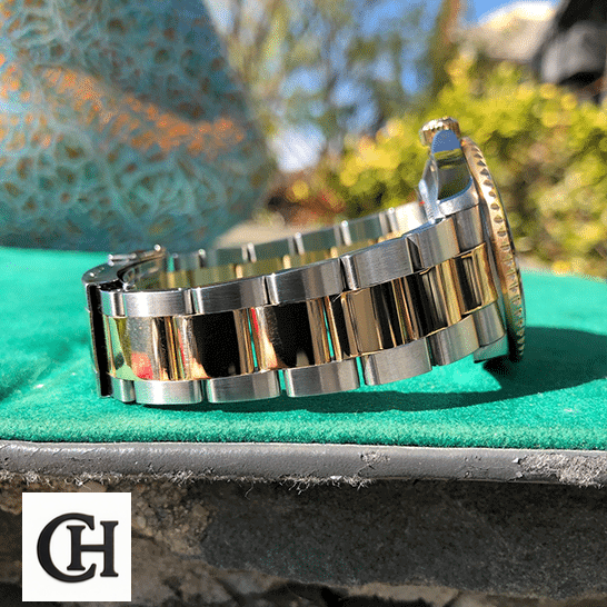 Rolex Submariner 16613 Rolex Submariner 16613 Serti Two Tone Stainless Steel Gold Diamond on the table