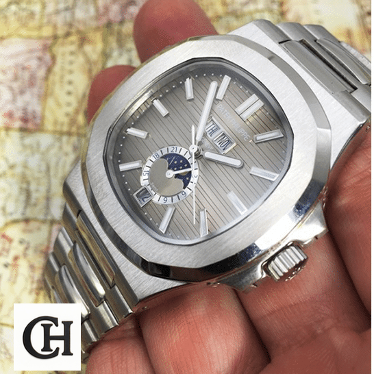 Patek Philippe Natilus Grey Dial Moon Steel on the hand map background