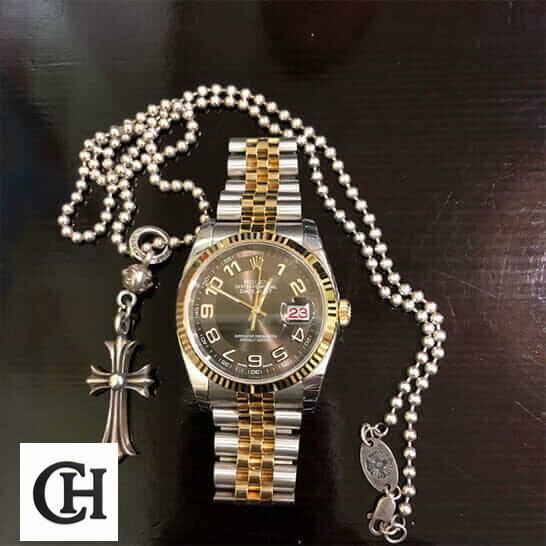 Rolex Datejust 116233-0209 Rolex Datejust Steel Yellow Gold 116233 next to the necklace