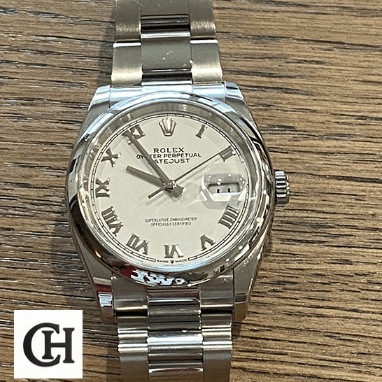 Rolex Datejust 126200-0008 White Dial rolex datejust 126200 0008 white Rolex Datejust 126200-0008 White dial on the table