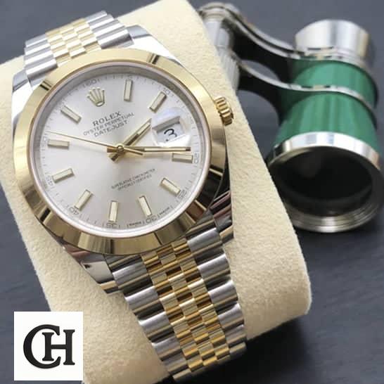 Rolex Datejust 126303-0002 Yellow Gold Super Accurate rolex datejust 41 gold unitedluxury Rolex Datejust 41 126303-0002 on cushion on the table