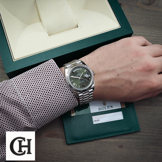 Rolex Day-Date 228239-0033 Rolex Day-Date Olive Green 228239 Rolex Box in front of on is arm