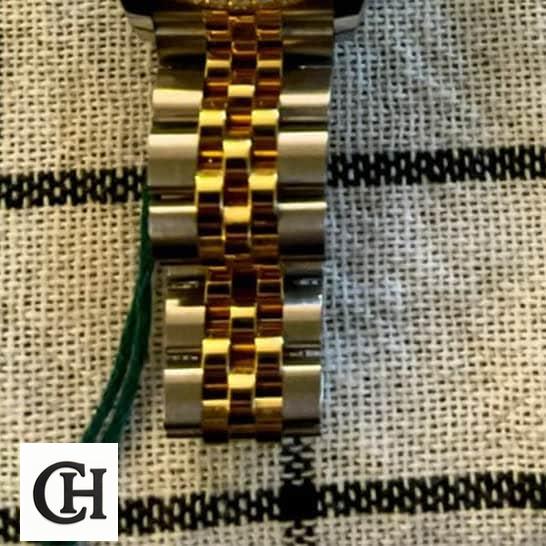 Rolex Lady-Datejust 279383RBR Champagne Diamond Master 5 5 Rolex Datejust 279383RBR-0003 Yellow Gold Jubilee Bracelet on the table