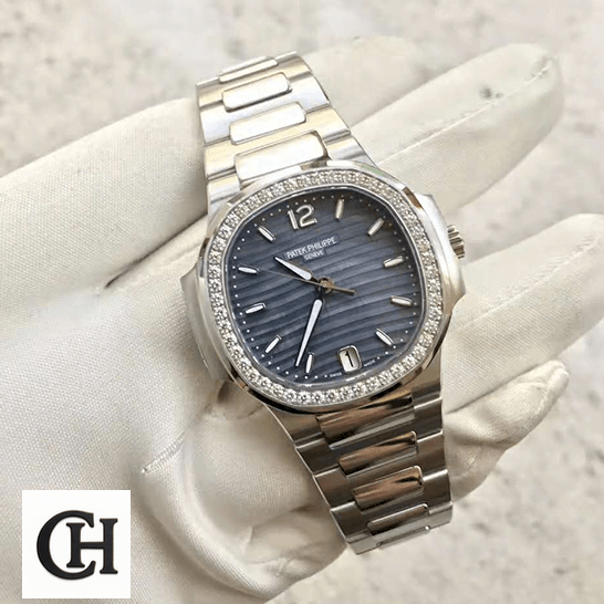 Patek Philippe Nautilus Ladies 7018/1A Elite Edition patek philippe nautilus 70181A front Patek Philippe Diamond Bezel Blue Dial Steel Bracelet on the white glove hand