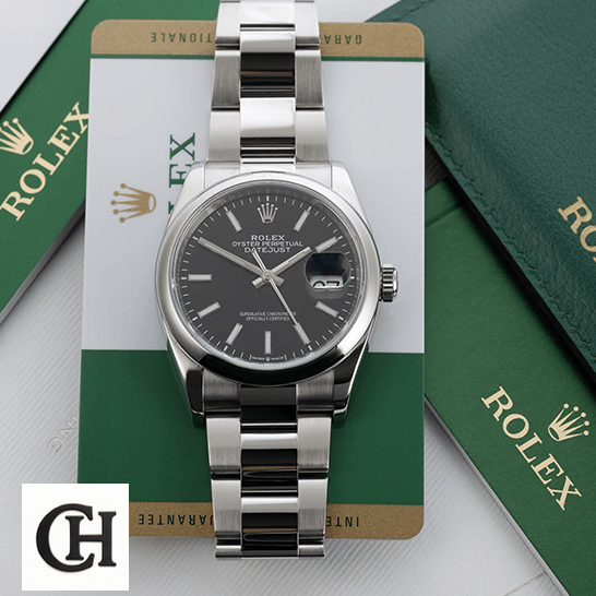 Rolex Datejust 115200-0004 Supreme rolex datejust 115200 0004 steel automatic silver dial oysterr dial Rolex Datejust 115200 Black Dial next to warranty card