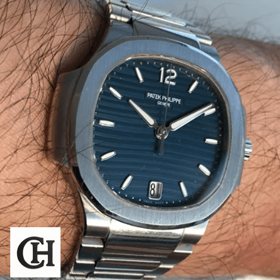 Patek Philippe Nautilus 7118/1A Ladies Perfect Duplicate patekphilippe nautilus 71181A 001 hand Patek Philippe Nautilus 71181A-001 Blue Dial Geneve on the man wrist