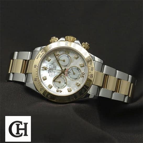 Rolex Daytona Two Tone White Dial 116523 on the black table