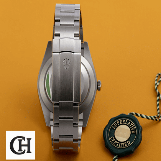 Rolex Oyster Perpetual 124300 Rolex Perpetual 124300 Stainless Steel Oyster Bracelet Fold Clasp on the Rolex Logo and Orange Background