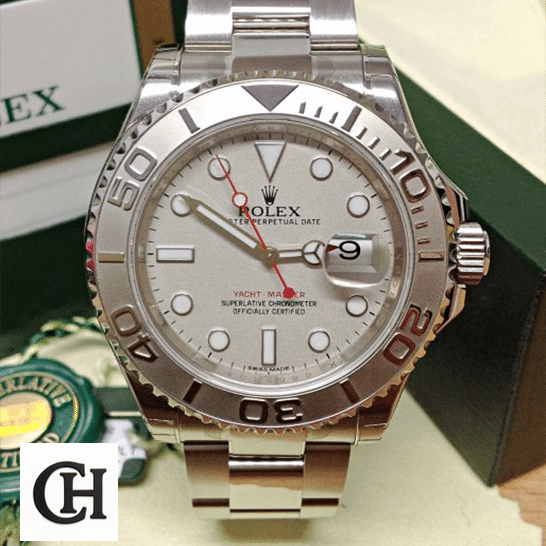 Rolex Yacht Master Platinum Dial Steel next to warranty card