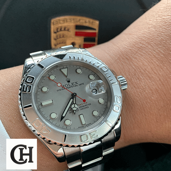 Rolex 116622PLSO Platinum Dial Steel porsche in the background