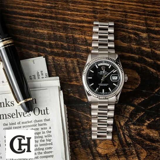Rolex Day-Date 228238 Rolex Day-Date 118239 on the table
