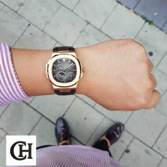 Patek Philippe Nautilus 5712R-001 Patek Philippe Rose Gold Case Black Dial Leather Bracelet on the man wrist